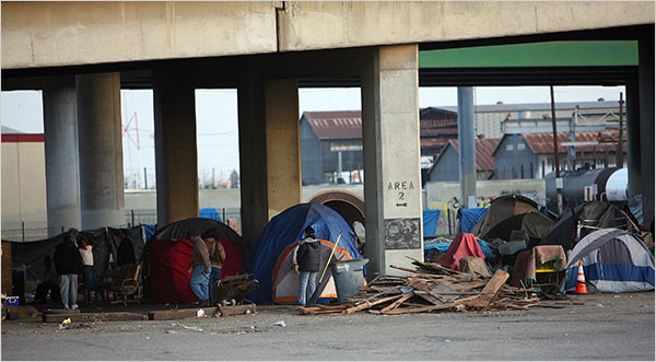 An encampment of tents under an overpass in Fresno